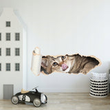 Funny cat licking own lips in paper hole